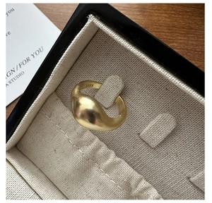 Close-up of matte gold wide ring showing S925 silver hallmark inside premium jewelry box