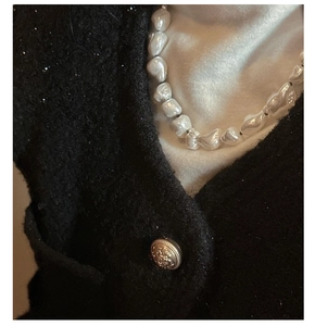Detail of baroque pearl necklace with irregular shapes and soft luster on a model
