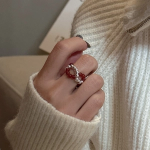S925 sterling silver red beaded crossover ring in a minimalist woven infinity design