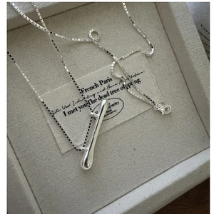 Macro shot of S925 sterling silver liquid pendant with hallmark in a jewelry box