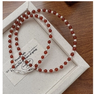 Close-up of S925 silver necklace with red agate beads and elegant lobster clasp