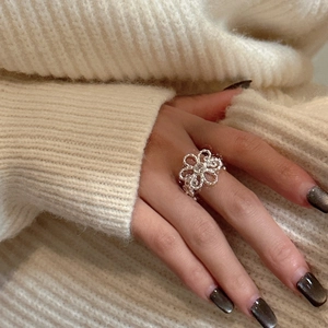 Minimalist S925 sterling silver hollow flower ring with pavé zircon petals on index finger