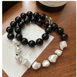 Detail of s925 silver necklace with black agate beads and irregular baroque pearls