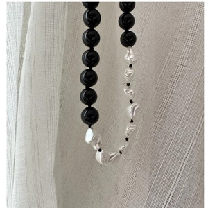 Detail of s925 silver necklace featuring baroque pearls and black onyx beads