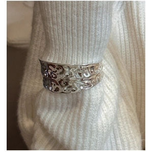 Detailed view of wide S925 sterling silver cuff bracelet with hammered metal texture