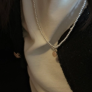 Elegant S925 sterling silver beaded coin necklace featuring a vintage round pendant