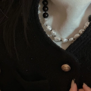 S925 silver black onyx and baroque pearl necklace styled on a black tweed jacket