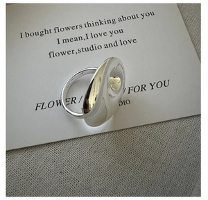 Macro shot of polished S925 sterling silver ripple ring with LOVE FOR YOU engraving