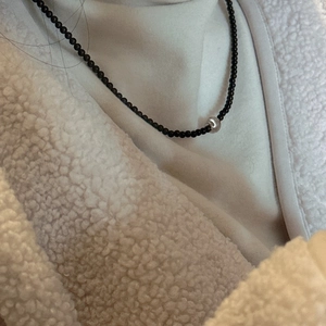 Elegant S925 silver beaded necklace featuring a central silver orb with black beads