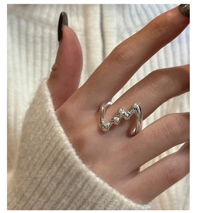 Macro shot of liquid metal style S925 silver irregular ring with wavy texture detail