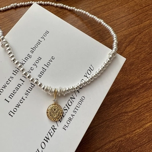 S925 sterling silver coin necklace with gold embossed pendant and crystal accent