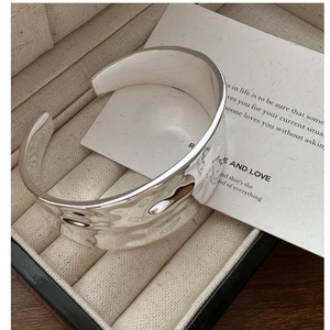 Detailed close-up of wide S925 silver cuff bracelet with hammered texture finish