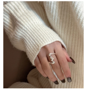 Close-up of S925 sterling silver liquid texture ring with irregular wave design