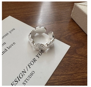 Detailed macro view of S925 silver ring featuring connected hearts and LOVE engraving
