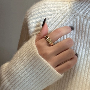 Minimalist S925 sterling silver golden ribbed ring shown on finger with soft knitwear