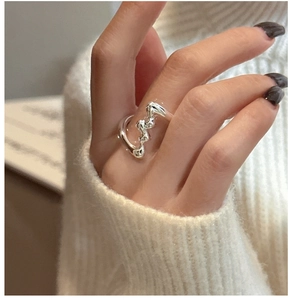 Close-up of S925 sterling silver wavy ring with liquid metal texture on a model