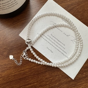 S925 sterling silver beaded necklace with white cat eye stones and heart charm detail