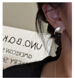 Close-up of minimalist S925 sterling silver earrings with black agate beads on a model