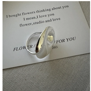 Close-up of S925 sterling silver ring with a polished large ripple surface and hallmark