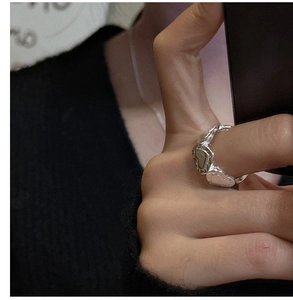 Macro shot of S925 sterling silver heart-shaped band ring worn on hand close-up