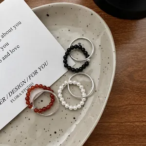 Three-color set of layered S925 silver beaded rings with pearl, black, and red accents