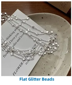 Detail of S925 sterling silver layered necklace with textured flat round beads