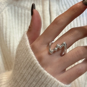 Minimalist S925 sterling silver liquid metal ring with irregular wavy design worn on hand