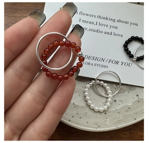 Minimalist S925 silver beaded rings with red agate and white pearl accents on finger