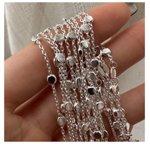 Detailed macro view of S925 sterling silver chain with textured circular beads