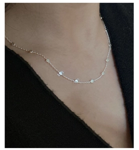 Detailed view of S925 sterling silver beaded chain necklace on a female neck