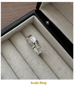 Detailed view of S925 sterling silver ring with scale texture in a black jewelry box