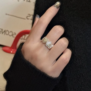 Minimalist S925 sterling silver ring featuring double heart texture on model's finger
