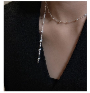 Detail of silver S925 Italian bead chain necklace on model with Y-shape drop design