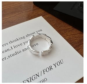 Close-up of S925 sterling silver ring with bamboo scale texture on a display card
