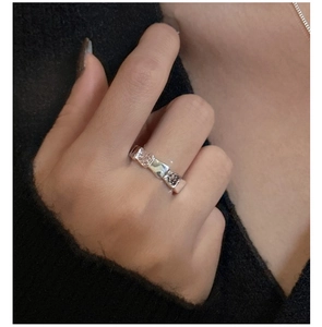 Close-up of S925 sterling silver ring with textured scale pattern on index finger