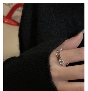 Close-up of S925 sterling silver ring with irregular hammered texture on female hand