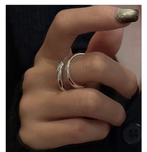 Close-up of S925 sterling silver double-layered ring with wavy texture worn on a finger