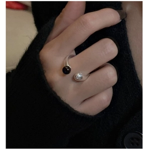 Close-up of S925 sterling silver open ring featuring a matte black agate bead detail
