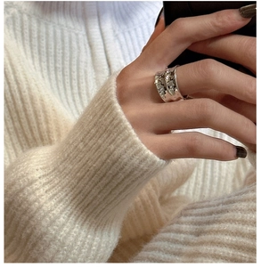 Detailed view of S925 sterling silver wide band ring with irregular textured surface finish