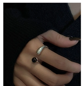 Macro shot of S925 sterling silver open ring with black agate bead on a hand