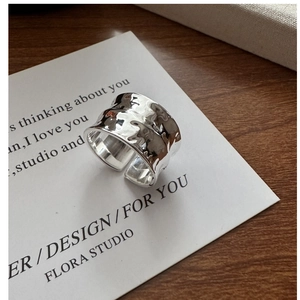 Macro detail of silver S925 ring featuring unique hammered texture and wide open band design