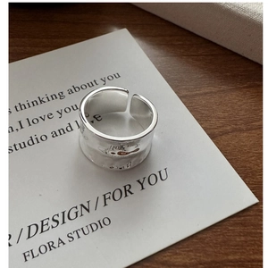 Detail of S925 sterling silver wide ring featuring hammer texture and small engravings