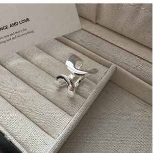 Detailed close-up of S925 sterling silver double-layer geometric ring on linen box