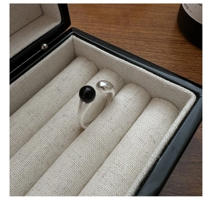 Detailed close-up of S925 silver ring featuring matte finish and a black onyx bead accent