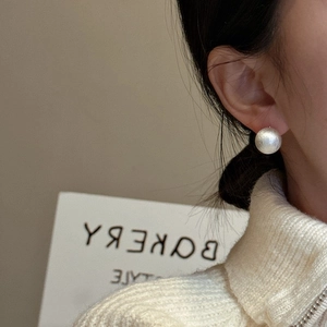 Minimalist S925 sterling silver ball earrings with brushed matte finish on female model