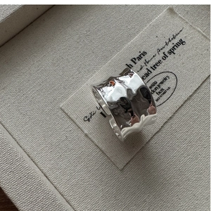 Detail of S925 sterling silver wide band ring featuring a unique hammered water ripple texture