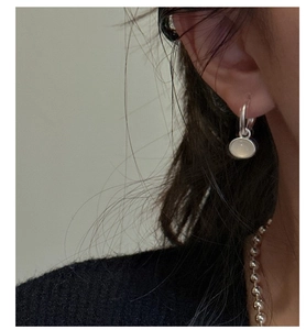 Detail of silver drop earrings with white agate inlay and matching beaded necklace set