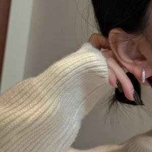 Textured S925 sterling silver hoop earrings worn by a model in a minimalist style