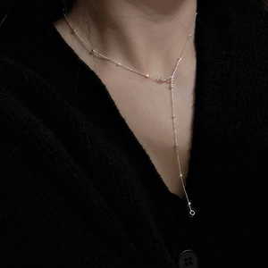 Minimalist S925 sterling silver Y-shaped necklace with fine beads on a female neck