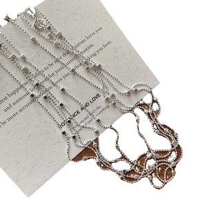 Elegant S925 sterling silver bead chain necklace with square charm on textured background